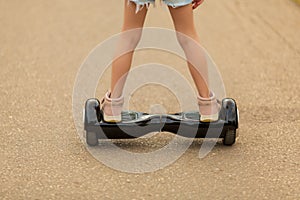 Girl rides a giroskuter in the summer on the square