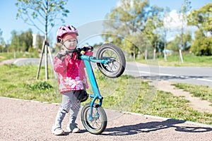 Girl rides in the Park on a blue runbike