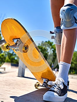 Girl rides on roller skates in skatepark.