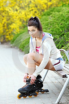 Girl rides rollerblades in the park