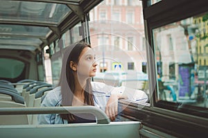 girl rides in the tour bus and looks out the window. Saint Petersburg, Russia.