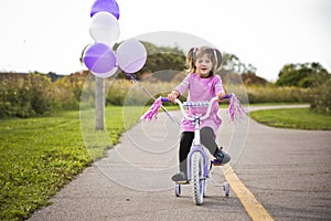 Girl riding a bycicle photo