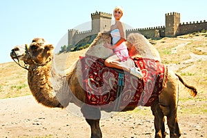 A girl riding a camel