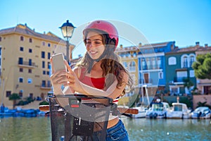 Girl riding a foldable e-bike in a Mediterranean marina