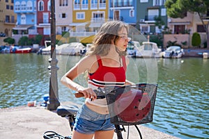 Girl riding a foldable e-bike in a Port