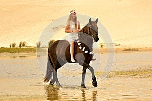 Girl riding her stunning Frisian horse photo