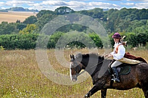 Girl riding horse in medieval dress