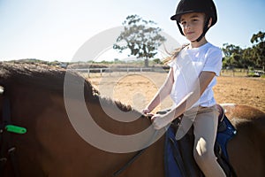 Girl riding a horse in the ranch