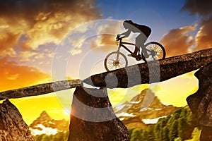 Girl riding a mountain bike at sunset.