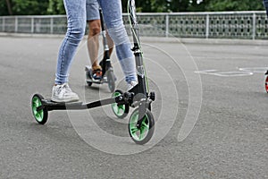 A girl is riding a scooter