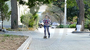 The girl is riding on a skateboard in the park.