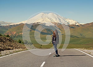 Girl Riding on skateboard on Road to Elbrus