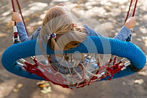 Girl riding a swing - basket