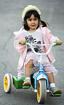 Girl riding tricycle