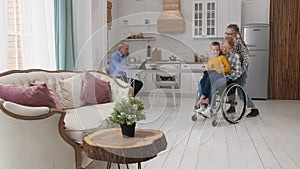 Girl riding wheelchair with grandma and brother