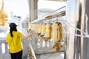 Girl ringing bells at temple