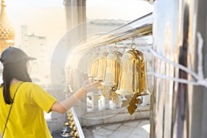 Girl ringing bells at temple