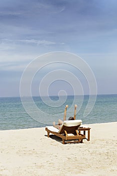 A girl rise her arms up for stretch her body after she wake up in private beach at Cholburi, Thailand