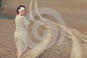 Girl on the road in field