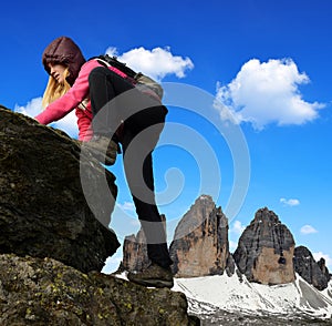 Girl on rock, in the background Tre Cime di Lavaredo