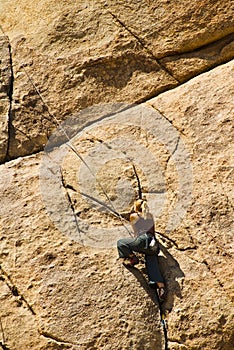 Girl rock climbing, Joshua Tree National Park