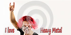 A girl rocker with red hair shows a hand gesture Heavy Metal HM on a white background, the inscription I LOVE HEAVY