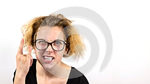 A girl rocker with yellow hair and glasses squinting one eye shows a hand gesture Heavy Metal HM on a white background