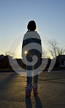 Girl on roller skates during sunset