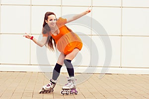 Girl rollerblading in street city