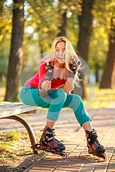 Girl on the rollers have fun in city summer park, enjoying healthy lifestile