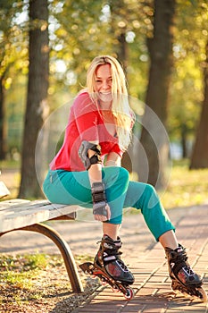 Girl on the rollers have fun in city summer park, enjoying healthy lifestile