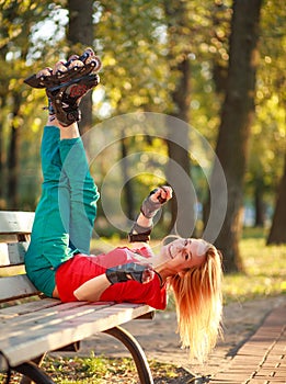 Girl on the rollers have fun in city summer park, enjoying healthy lifestile