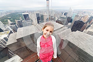Girl on roof of a skyscraper with reflection in