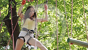 Girl on a rope climbing in park