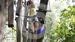 Girl on a rope climbing in park