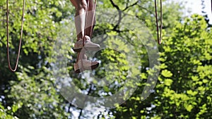 Girl on a rope climbing in park