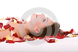 Girl in rose petal. Spa resort.