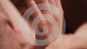 girl rubs hand cream in her palms. Close-up