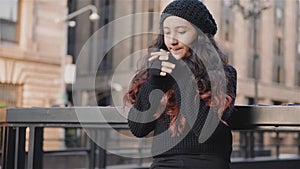 Girl rubs her hands because it is a cold urban image