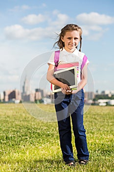 Girl with a rucksack on his back and a tablet in