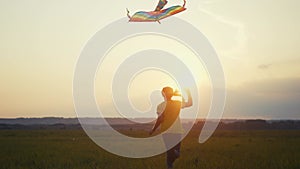 girl run with a kite in the park at sunset. fantasy happy family dream kid concept. child run park play with toy kite