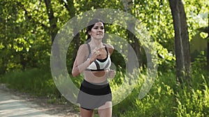 girl on a run. young woman running along the road at sunset. athlete jogging. slow motion