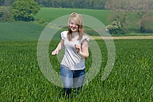 Girl running across a field