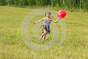 The girl running across the field in summer day