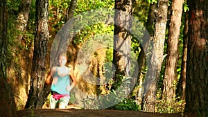 girl running along narrow footpath in forest