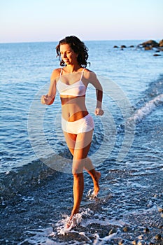 Girl is running on the beach