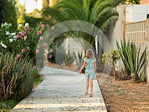 Girl running in the distance on a park path