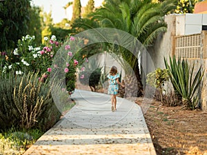 Girl running in the distance on a park path