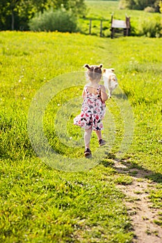 girl running after a dog, happy childhood, pet