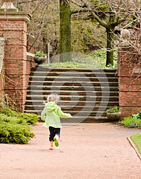 Girl running through a garden